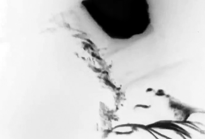 Black-and-white film still from The Cow by Dariush Mehrjui, showing an overhead opening in a village dwelling with light flooding down into the dark interior