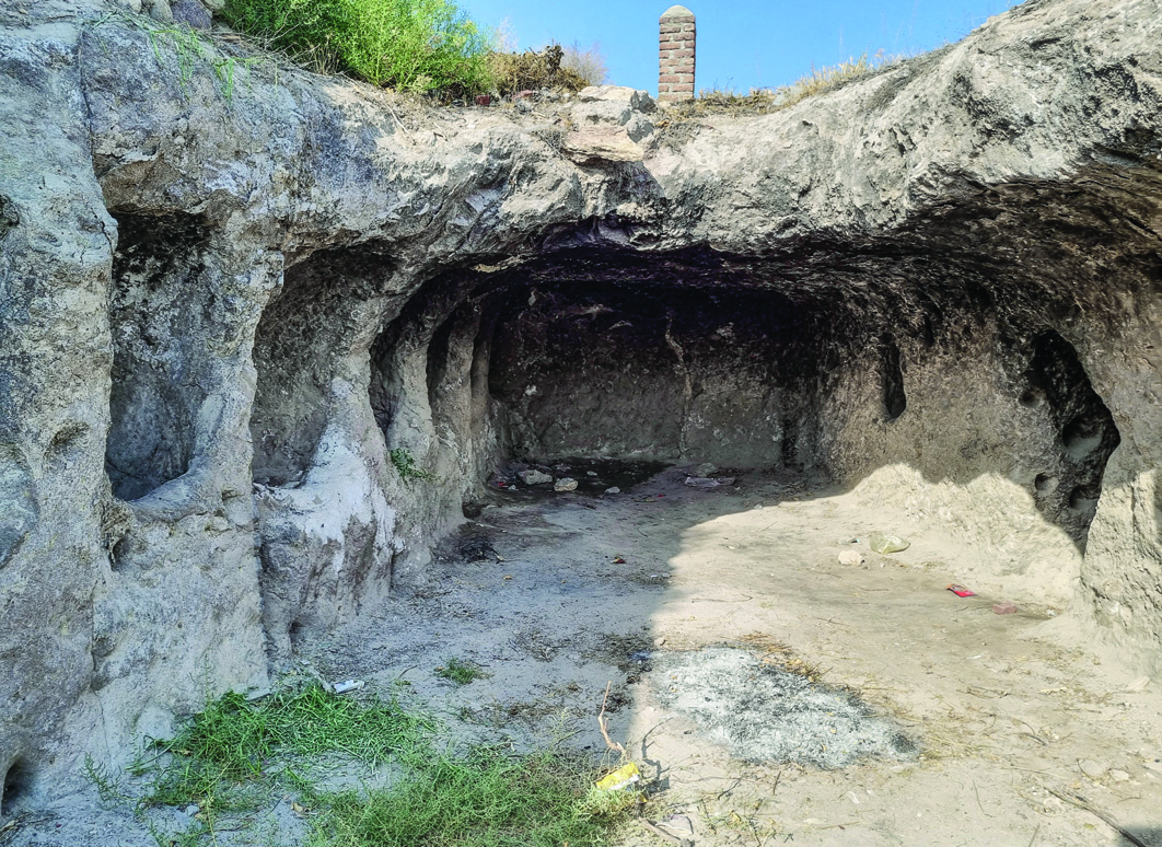 The rock-hewn underground stable (setūrkhāneh) near the Varjovi Mithraeum, showing a vaulted cave entrance