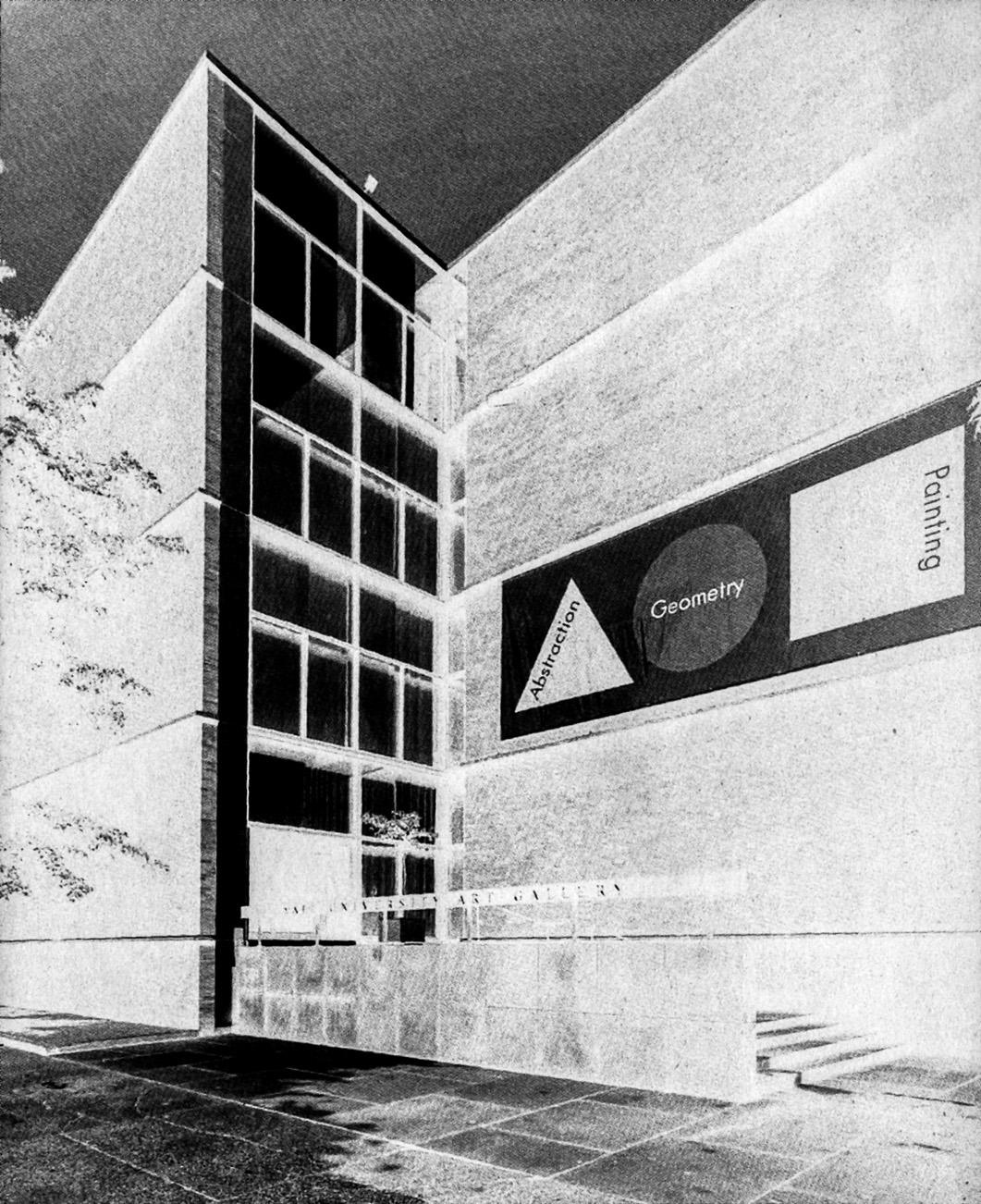 Exterior of the Yale Art Gallery entrance with a banner reading 'Abstraction, Geometry, Painting' above the glass doorway, showing the brick facade and concrete frame