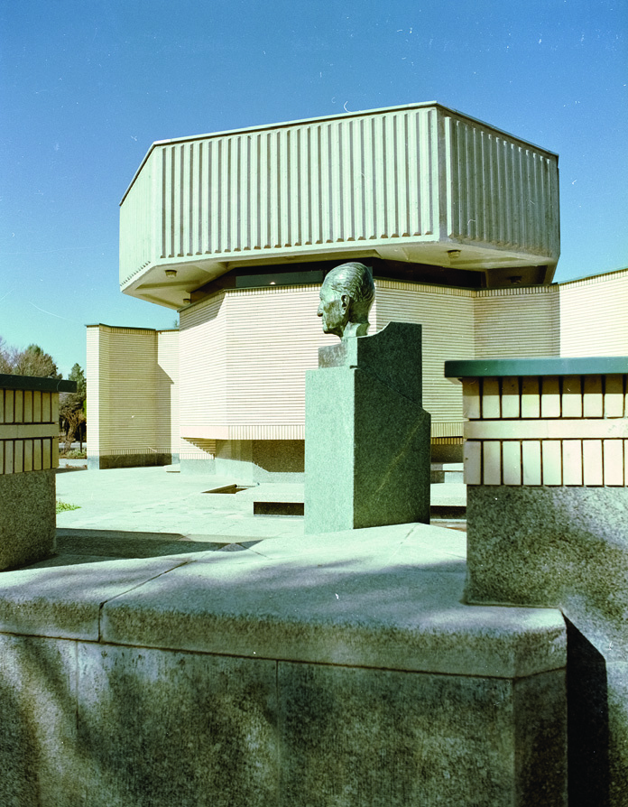Afzalipour Museum with bronze bust of the university founder and conference hall in background