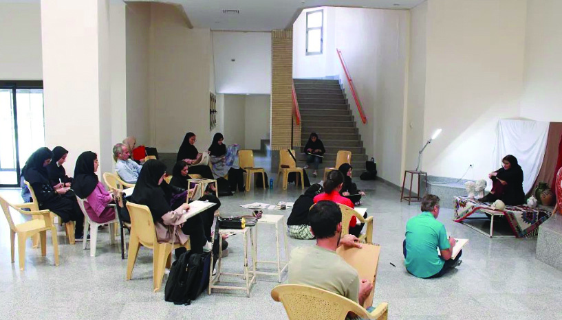 Art class held in a large atrium space with students drawing and sketching
