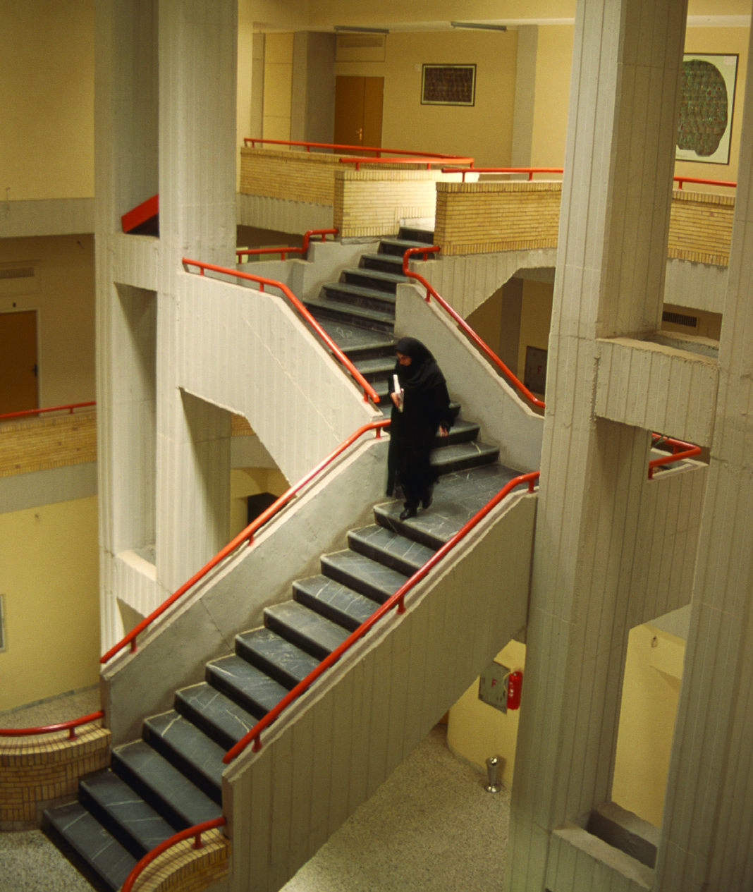 Interior atrium with interconnecting staircases and red railings