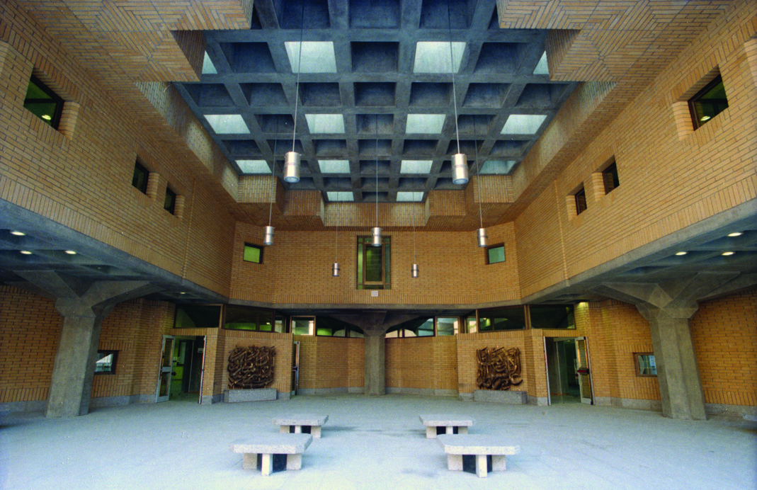 Interior courtyard of the National Library with brick walls, coffered ceiling, and skylights
