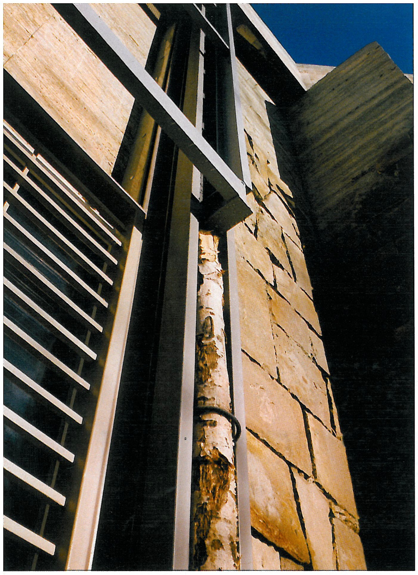 Exterior of House No. 3: a broad white volume, irregular openings beside the brick faces