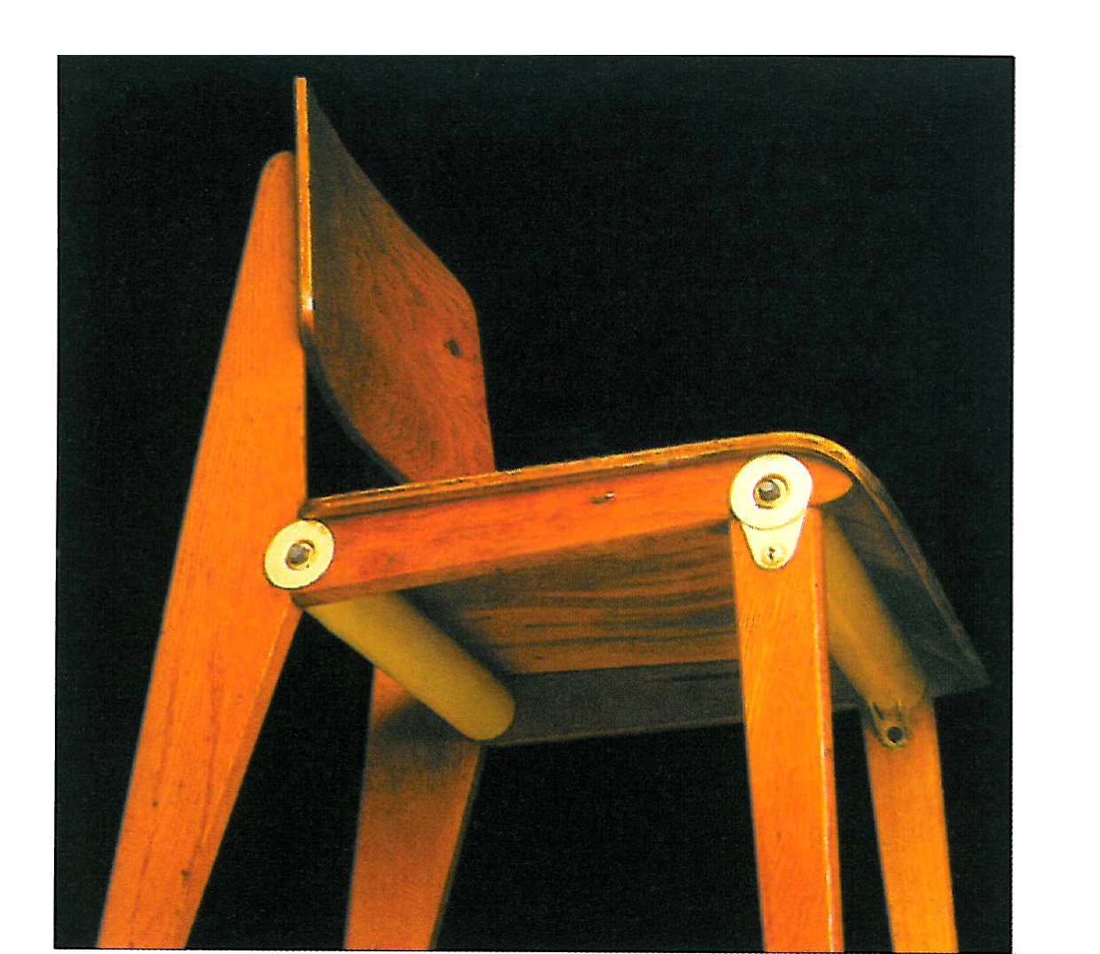 Prouvé's Standard Chair: exposed metal frame, timber seat, a striking example of the packed-form