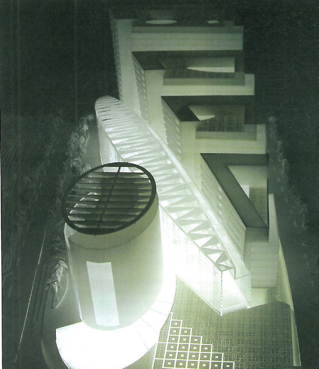 Entry 2 (Gueno+NORR) — night view of the glass-enclosed central atrium