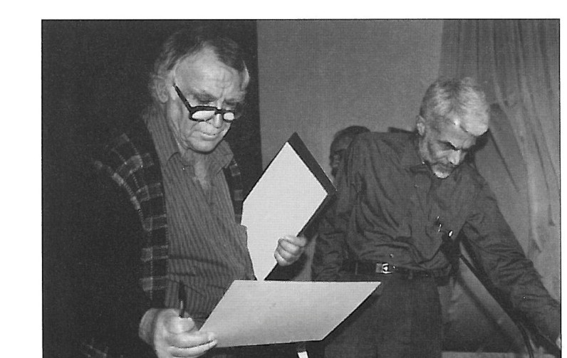 Two jurors examine a submission during the judging