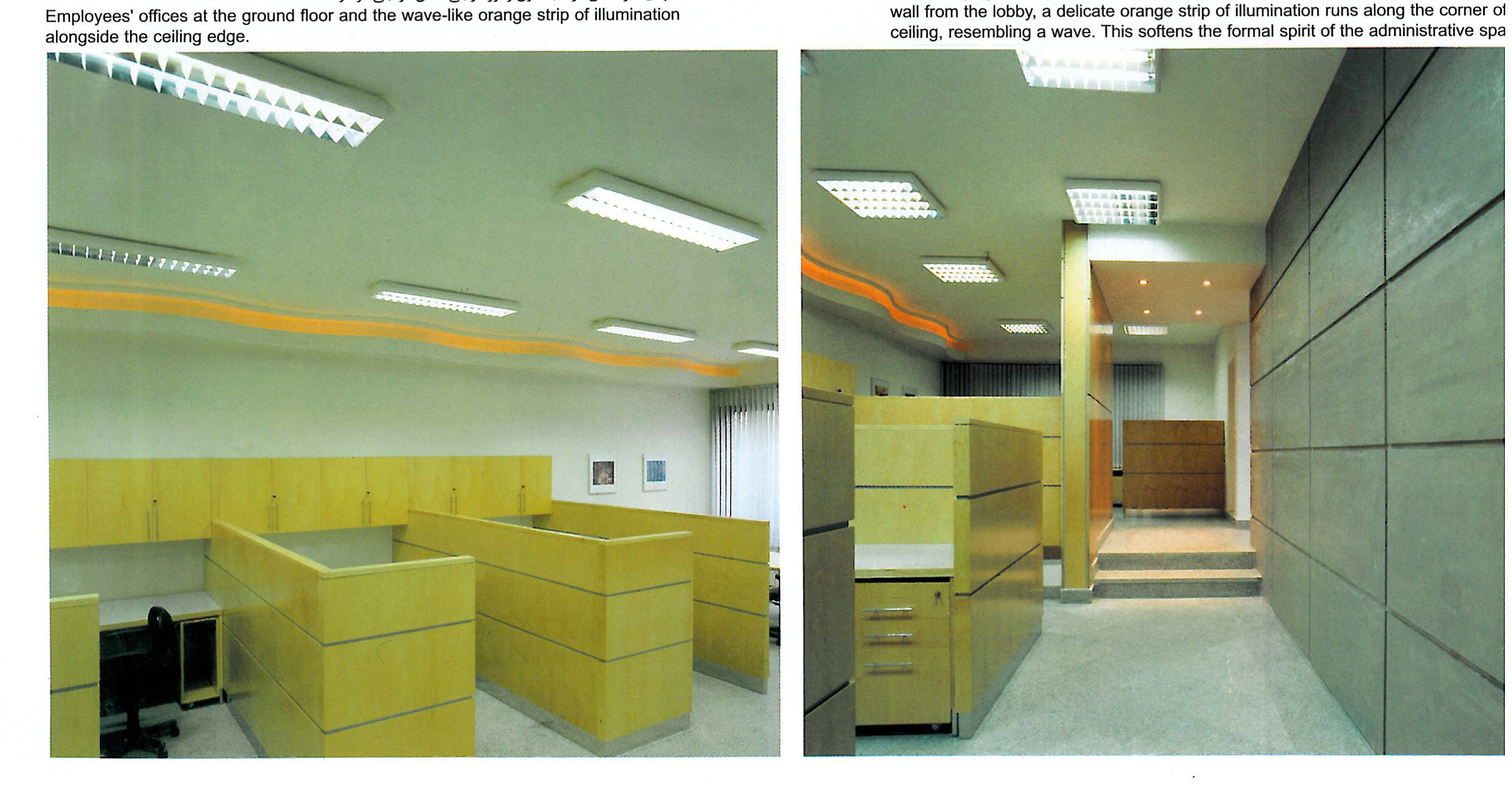 Office at the second mezzanine — square modules visible on the wall, light through glass bricks