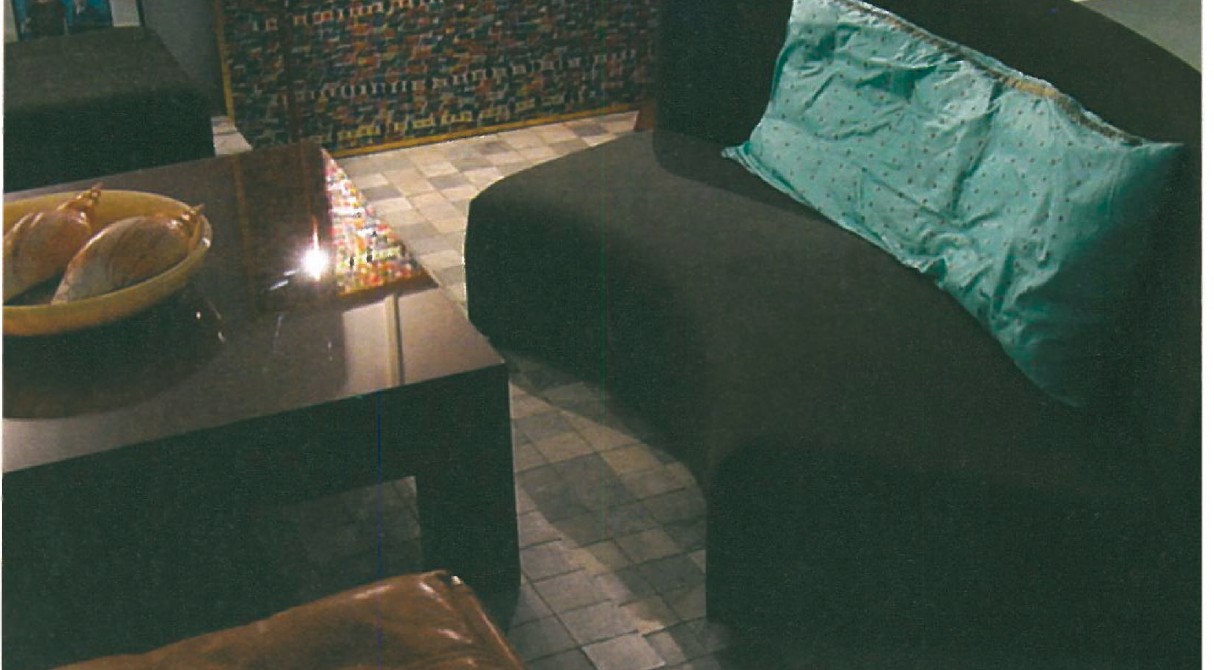 Living room with a 1/4-circle T.V. sofa, Cloth-of-gold and silk large-scale cushions, square ox-blood lacquered table, leather X stool of Egypto-Japanese inspiration, large painting by Zenderoudi (1977) and photoworks by Makiksh Nayini