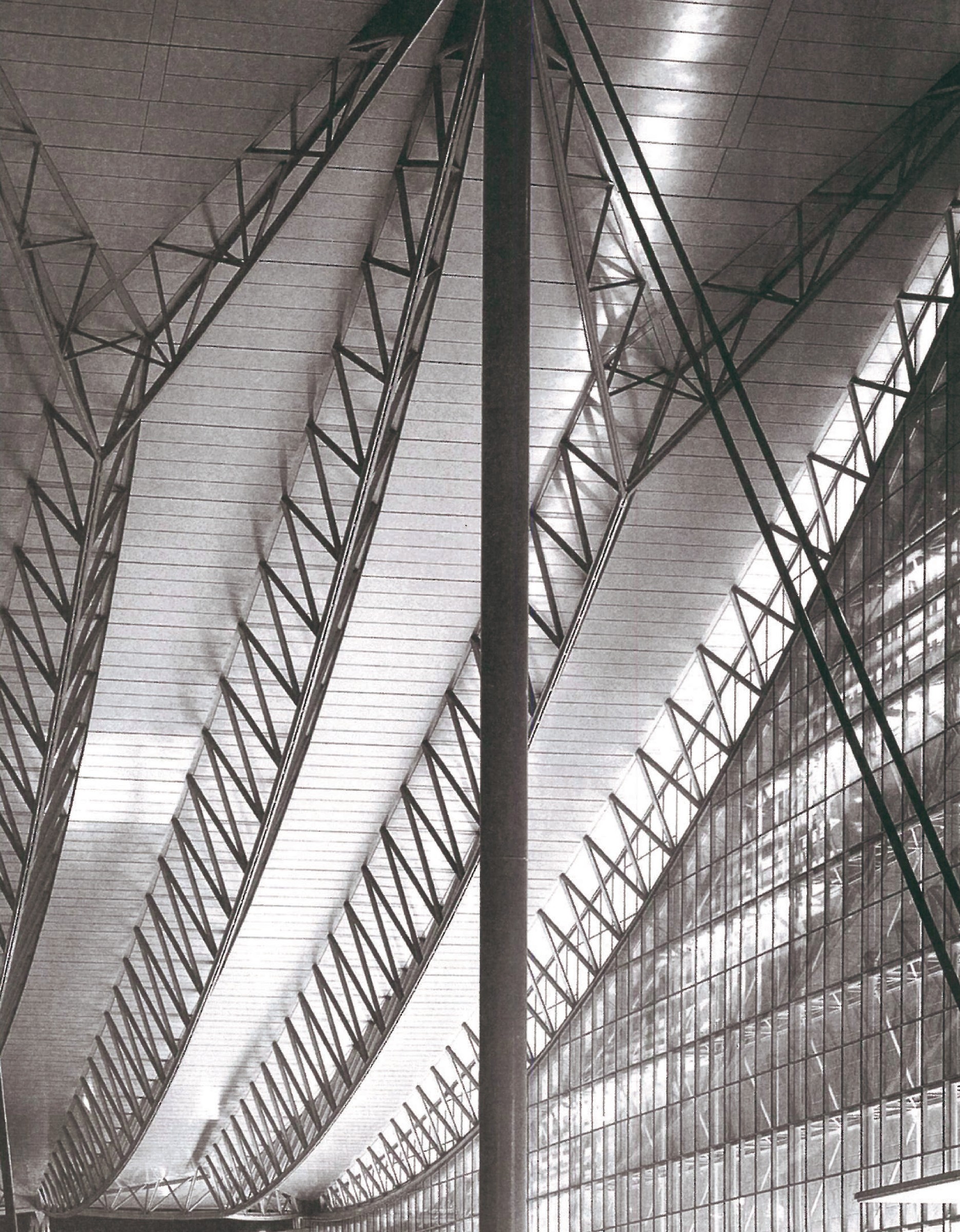 Iconic monochrome interior view of Makuhari Messe Phase 2: long-span steel trusses descending toward the canopy edge