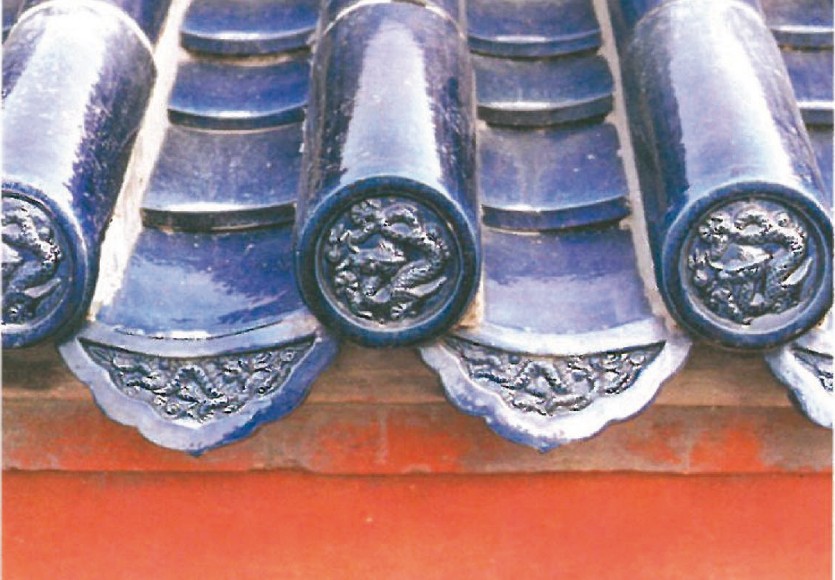 Detail of the dark blue and yellow glazed roof tiles of the Forbidden City — dragon-end ridge tiles
