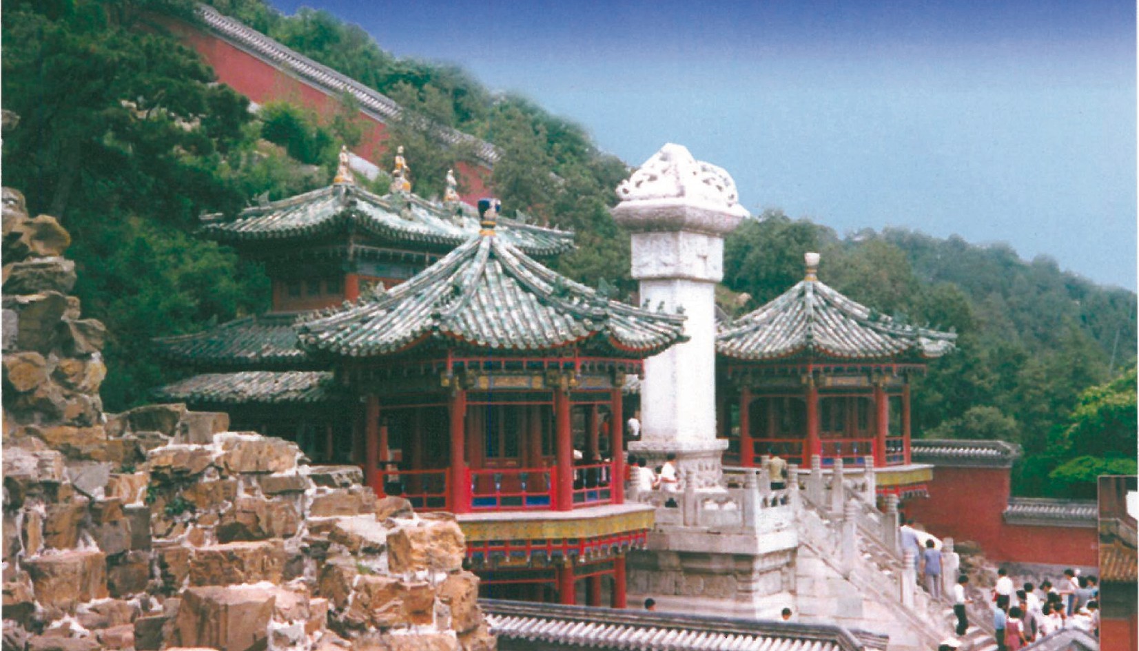Glazed-tile roofs of the Forbidden City in Beijing — yellow ceramic tiles, ridge ornaments and stone column