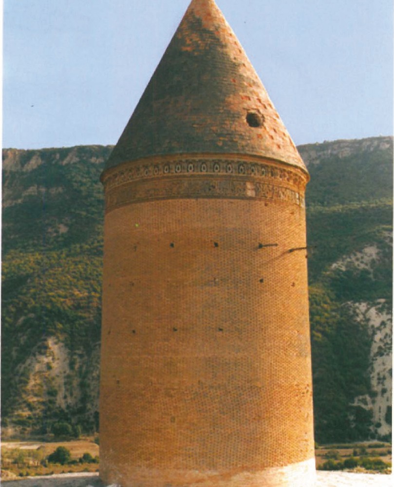 Cylindrical brick funerary tower of Radkan Kordkooy in Iran, with a steep conical brick roof