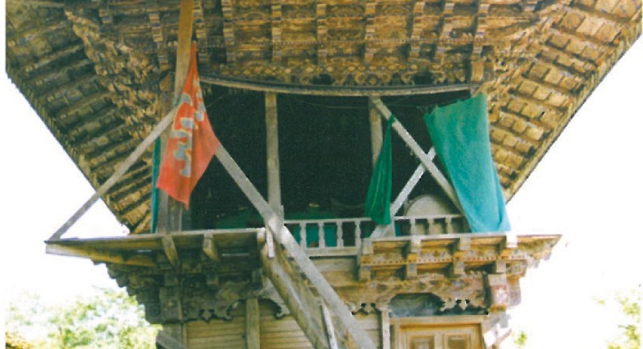 Carved-wood roof eave with hanging colourful tassels at the Saghantar Kijatekiyeh in Iran