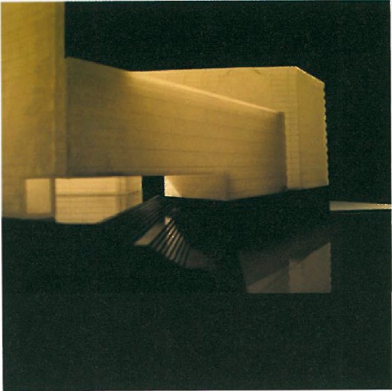 Cardboard study model of the 3rd-place Bon Sar / Majidi proposal showing the triangular massing from a low angle
