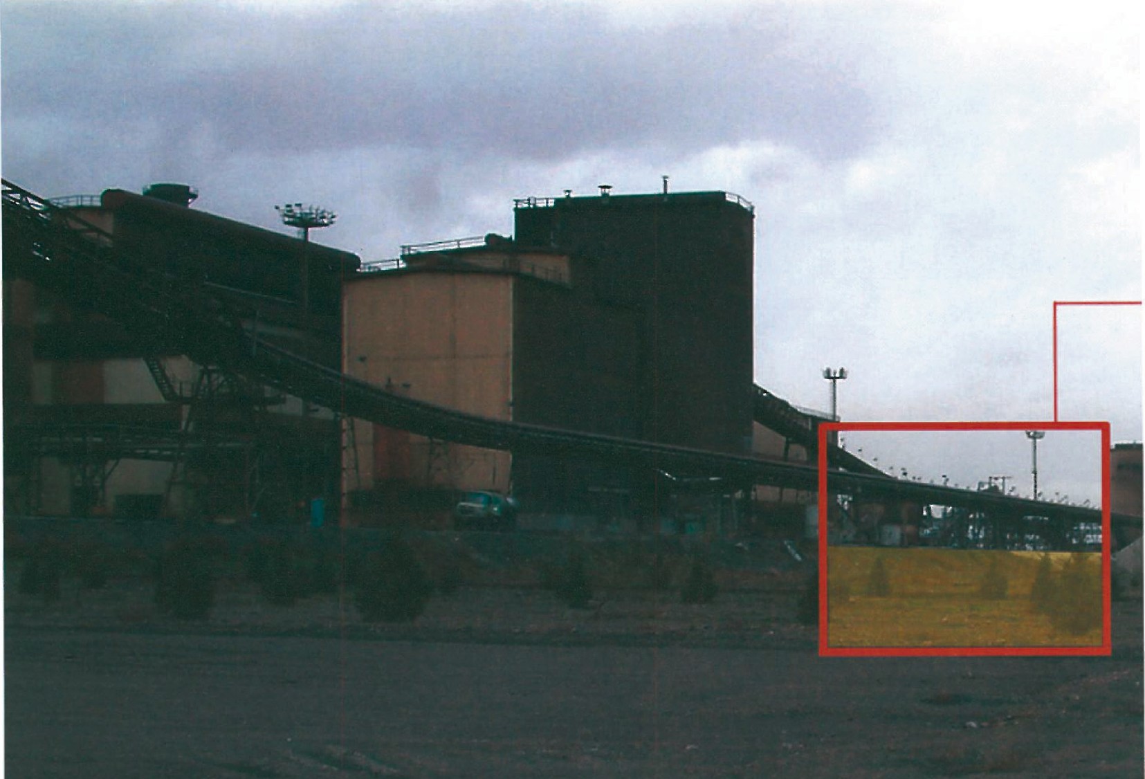 Industrial site of Mobarakeh Steel Complex with overhead conveyor structures and factory halls; the future project plot is marked in red