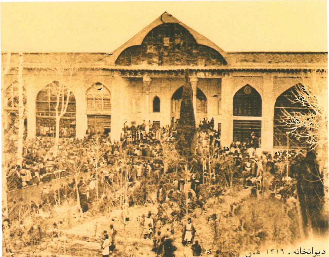 Historical photograph (Qajar period) of the Tribunal court at the Karim Khan complex, with crowds gathered in the courtyard
