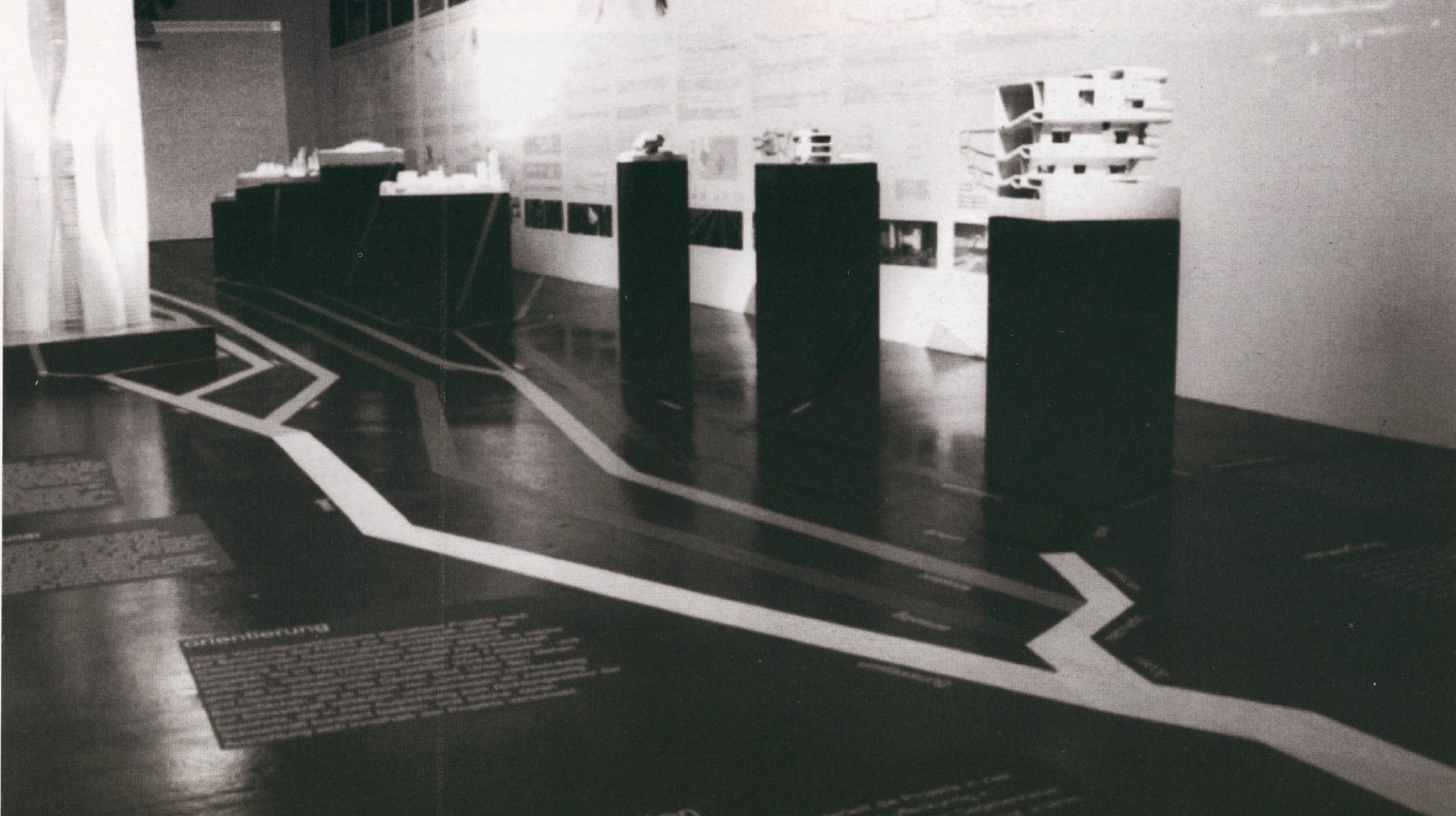 Exhibition hall at the Vienna MAK museum (June 2003): wood-floor plinths displaying FOA's project models