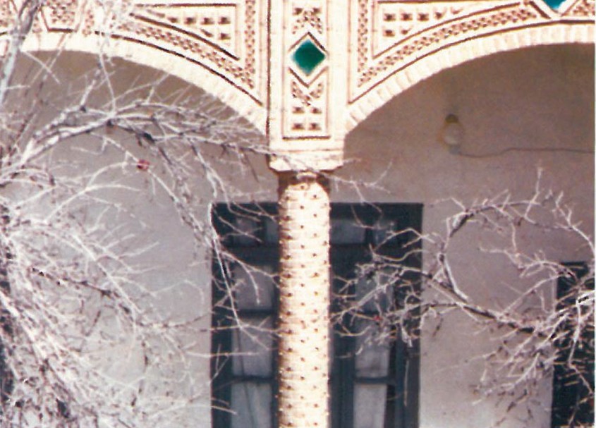 Detail of an ornamental brick column at Example 11 in the Birjand survey: spirally wrapped column with diamond-shaped green-glazed tile inserts in the spandrel and patterned brickwork above