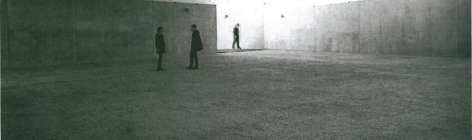 Empty interior of the Art Museum of Bregenz with two visitors standing on the 470 m² rammed-earth floor that Martin Rauch produced for Olafur Eliasson's installation