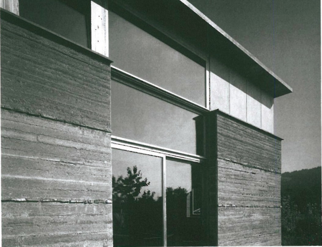 Detail of a private house in Rankweil, Austria, showing the layered 63 cm rammed-earth ground floor wall combined with timber cladding above