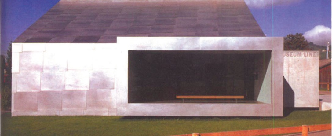 Museum Liner by Gigon & Guyer in Appenzell, Switzerland — a long horizontal pavilion clad in matte sand-blasted steel panels, with a deep rectangular opening cut into the upper volume