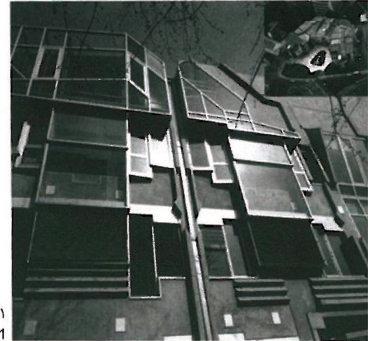 Sculptural sheet-metal stair-and-window assembly on the Biochemical Faculty Building in Graz by Karla Kowalski and Michael Szyszkowicz — irregular metal panels, vertical louvres and stacked window frames against a dark facade