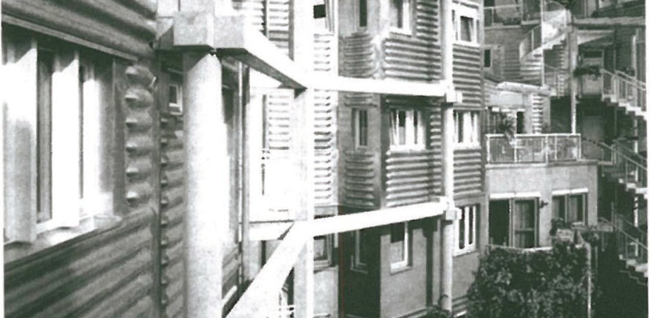 Exterior view of Richard Meier's Handcraft Arts Museum in Frankfurt (1979-1985) — pavilion volumes faced in his signature white panels, set in a wooded site with a slender steeple in the distance