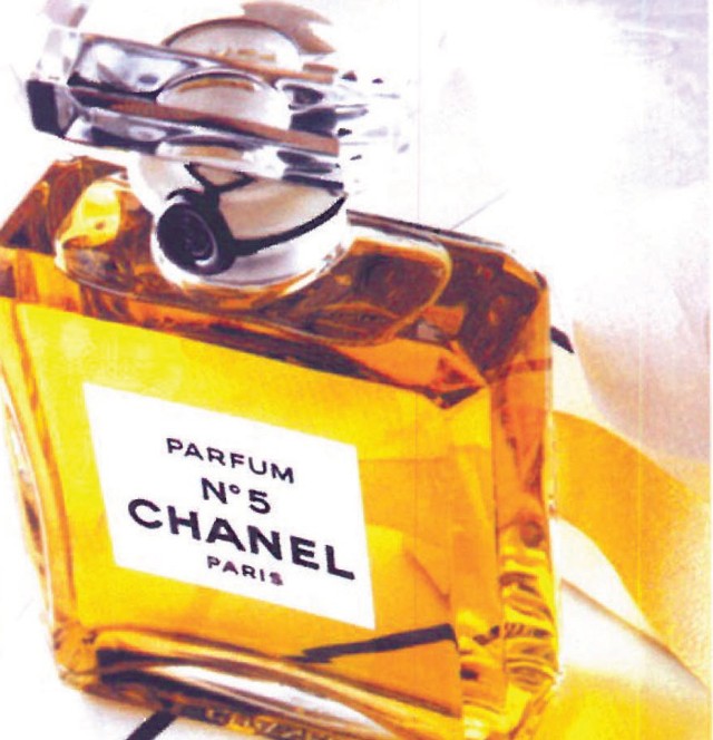 Iconic Chanel No. 5 amber perfume bottle, the 1924 Bross Glassworks design with its rectangular glass body and black-bordered label