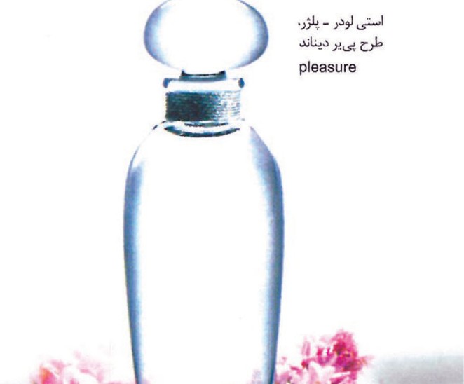 Tall faceted clear Estée Lauder Pleasures perfume bottle on a bed of pink blossoms