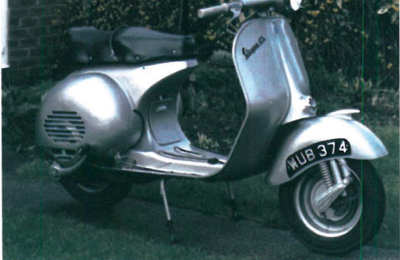 Black early-production Vespa 125, registration KUB 374, photographed in profile to show the original 1940s body lines