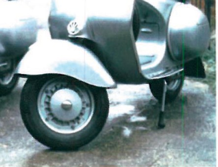 Restored two-tone Vespa 125 with chrome mirrors, registration BSN 800, photographed in profile against a neutral wall