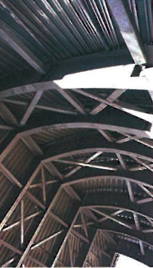 Diagonal braced steel frame inside Walt Disney Concert Hall, dense criss-crossing members supporting the curved upper roof
