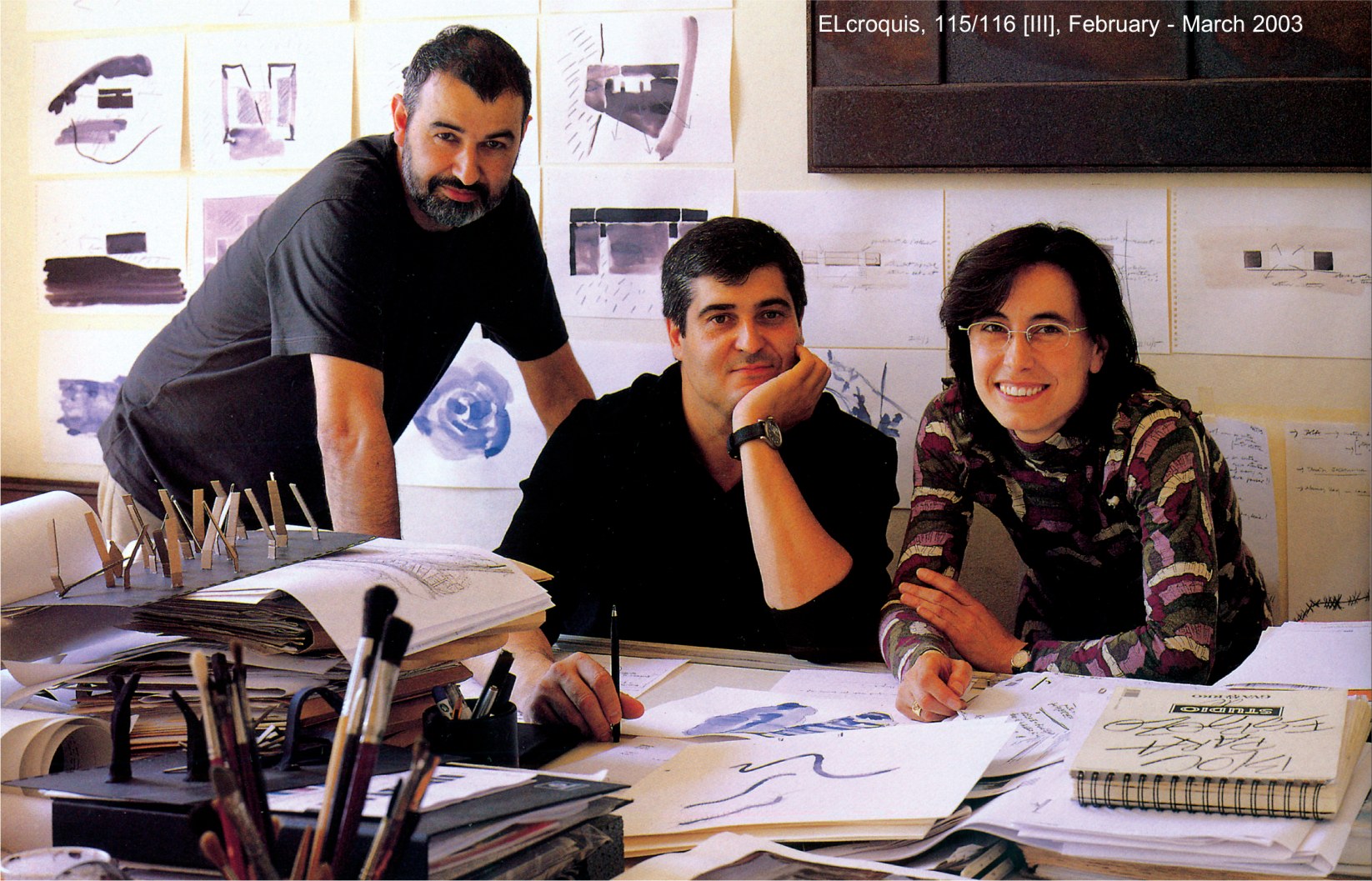 Group portrait of RCR architects (Aranda, Pigem, Vilalta) at their drawing table