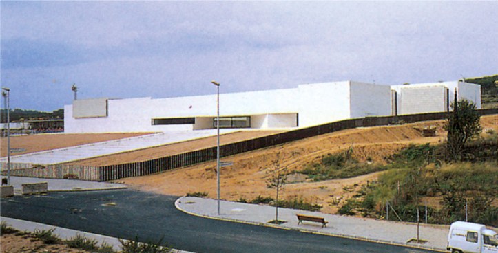 Villaragues Secondary School by RCR, a long white modernist school building with a curving access road