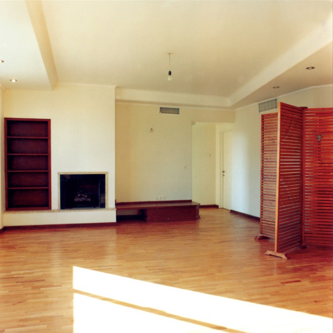 A living room with shuttered openings.