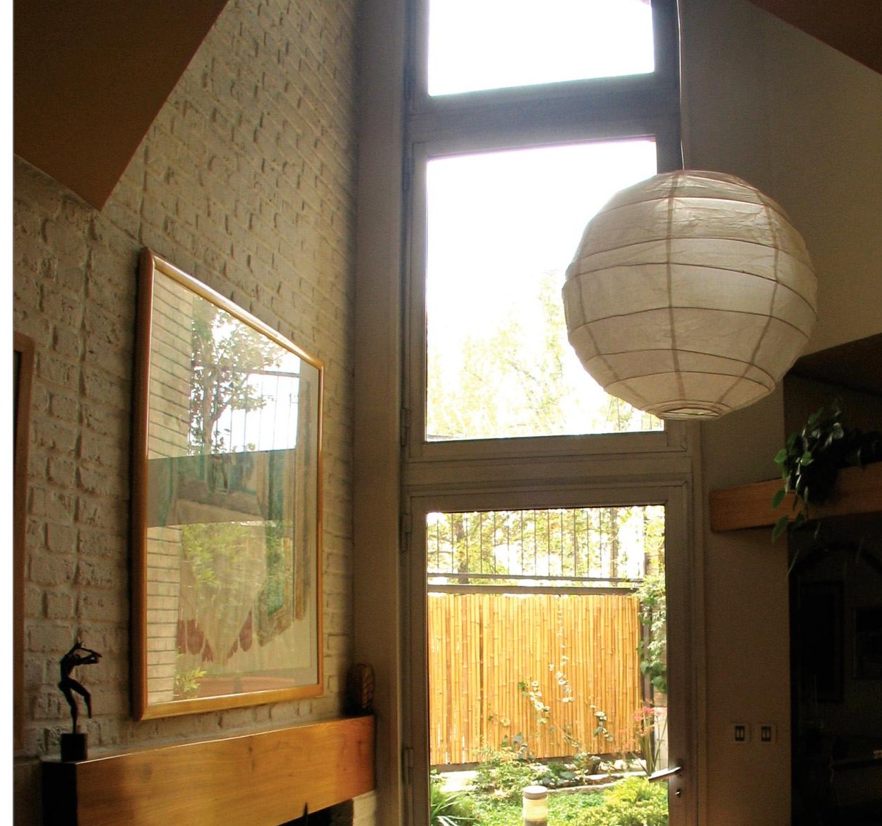 The architect's house: the double-height living room with fireplace and view to the garden.