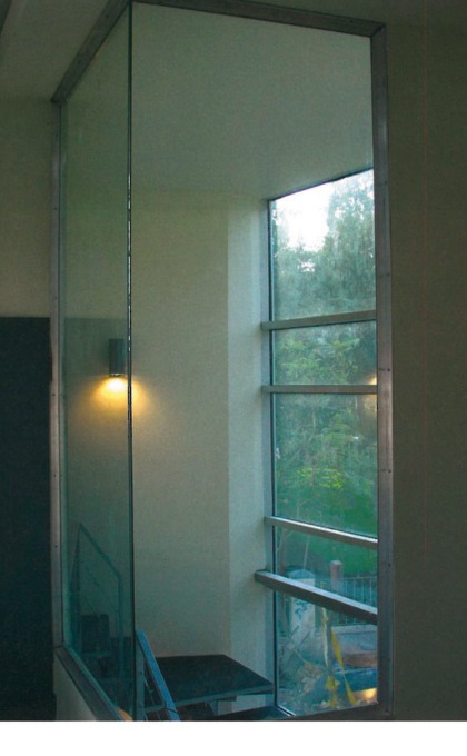 View from control room through glass void to garden