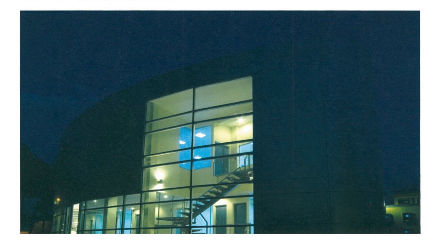Tehran Telemetry Center exterior at night showing glass curtain wall and staircase