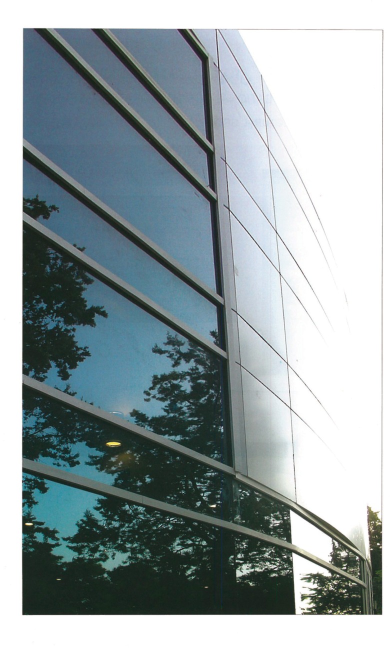 Tehran Telemetry Center facade detail with tree reflections in glass panels