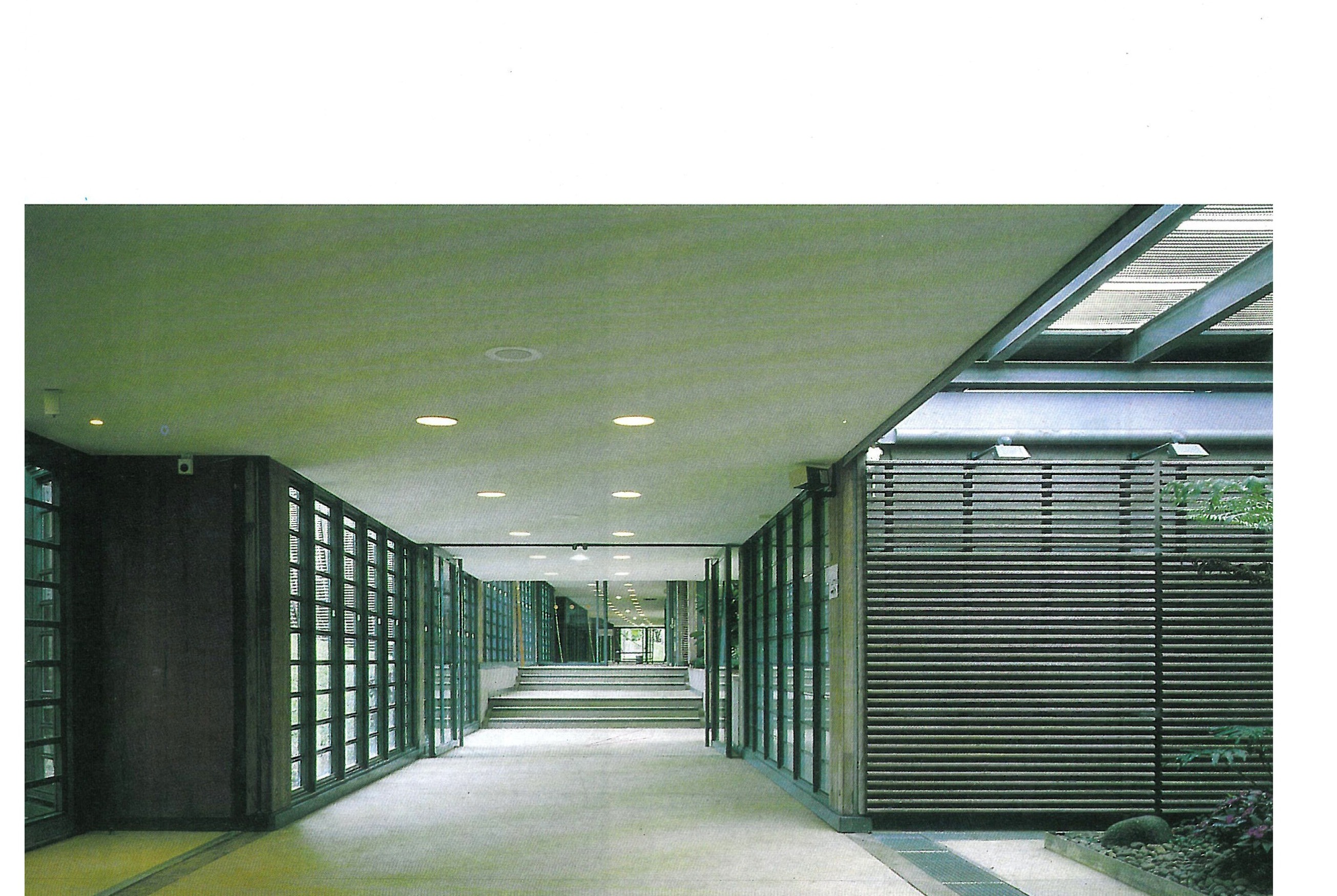 Interior — the corridor linking the shells, the louvred wall on the lagoon side