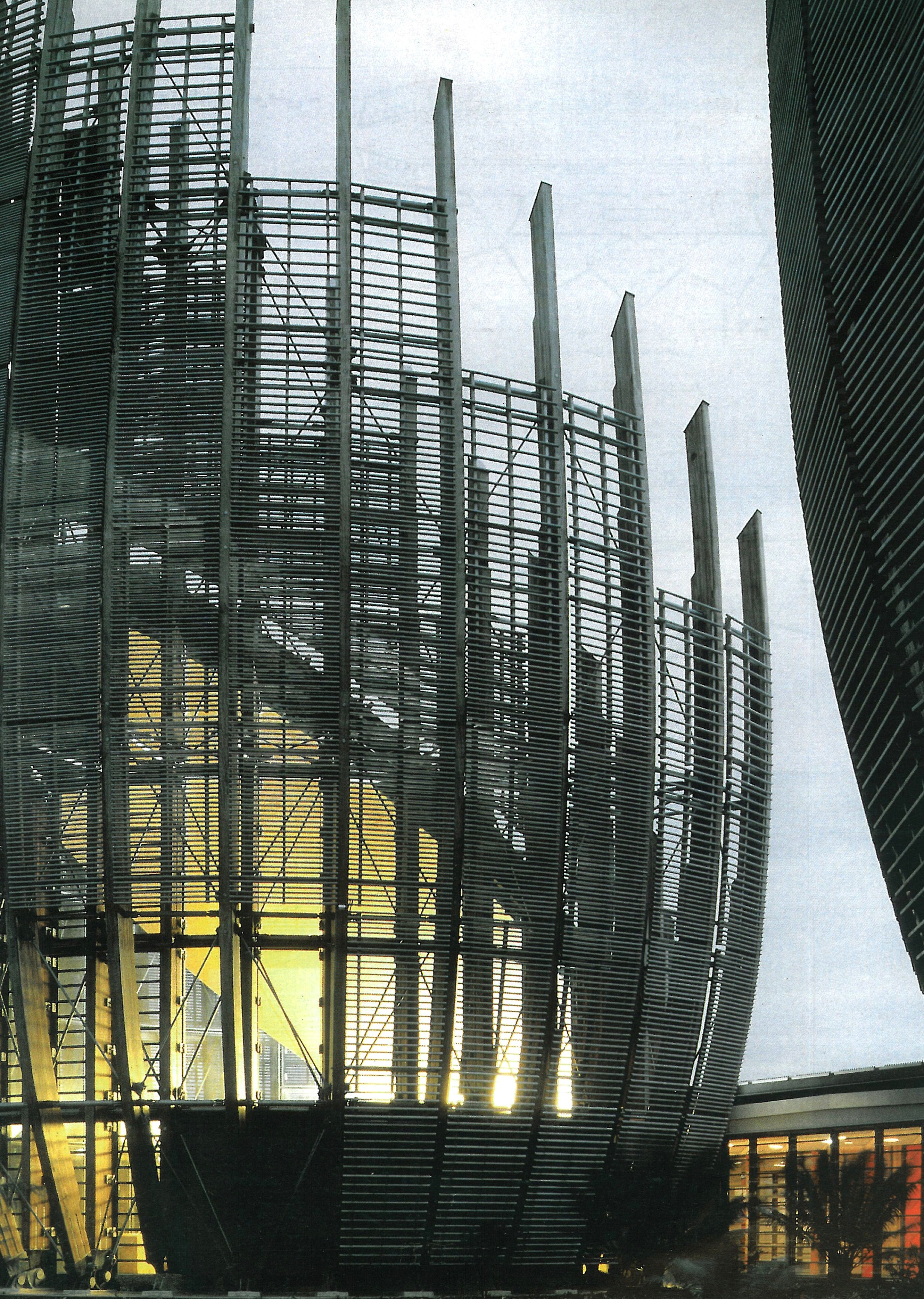 Shell exterior at dusk — the timber slats around the lit interior