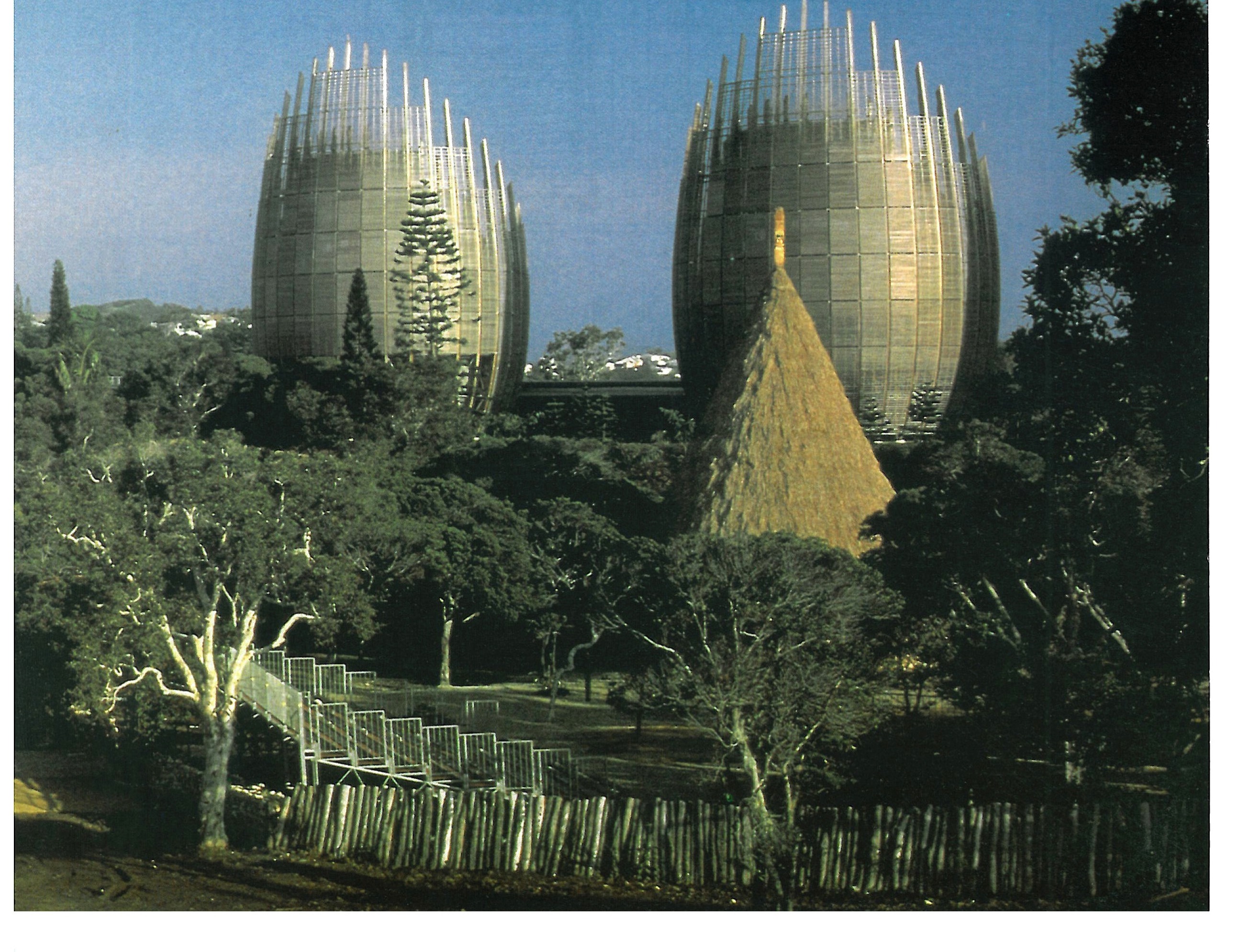 Wooden shells beside a traditional Kanak conical hut