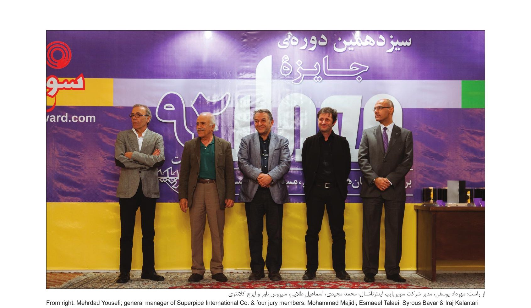 Group photo of jury members on stage and Mehrdad Yazdani at the jury session