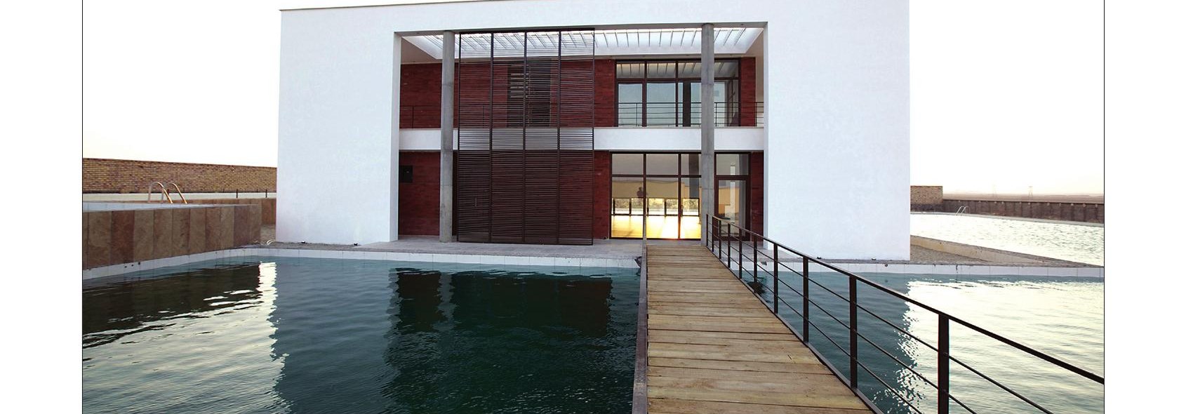 Entrance bridge across the pool to the recessed villa portal