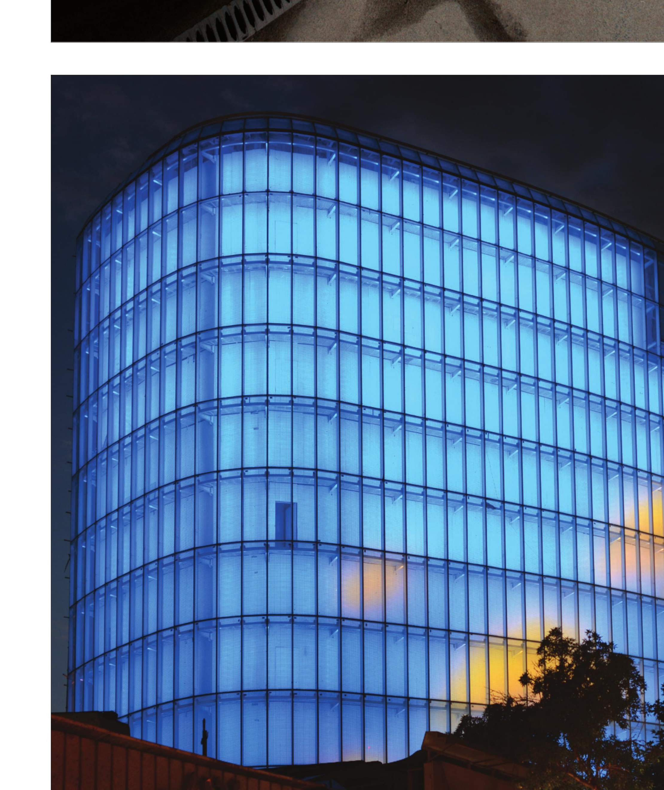 Backlit glass volume at night.