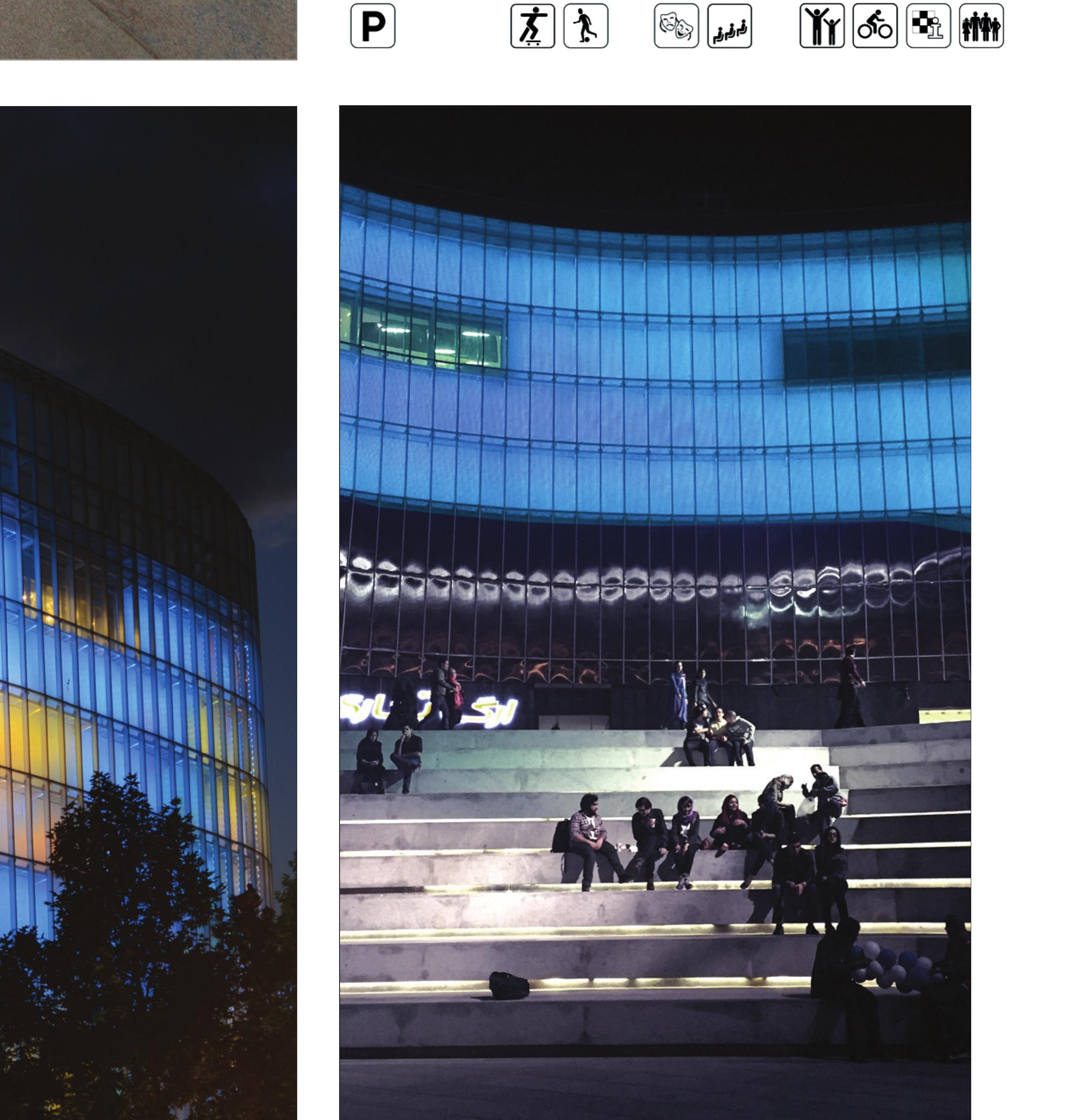 Visitors on the stepped plaza at dusk.