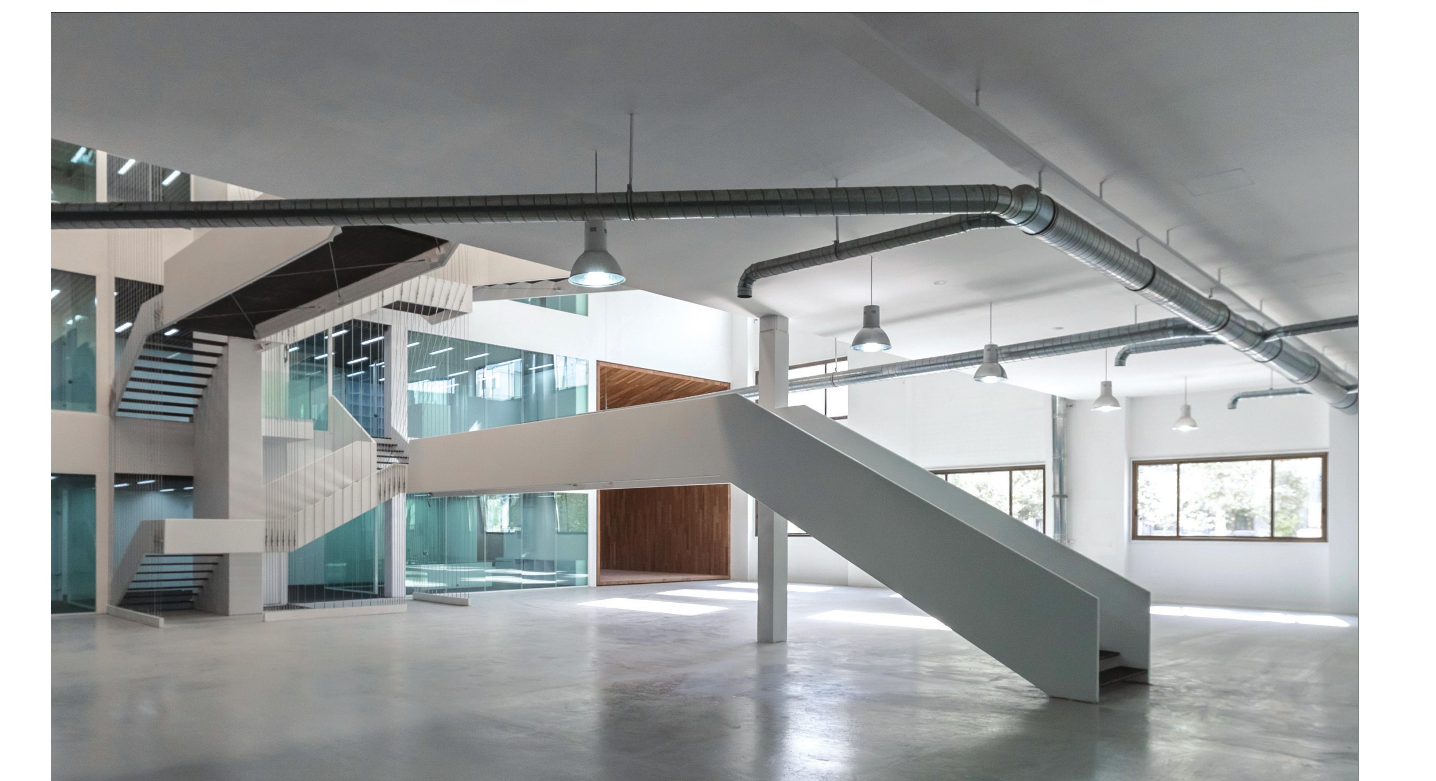 Main hall with the cantilevered bridges and the steel-plate stairs.