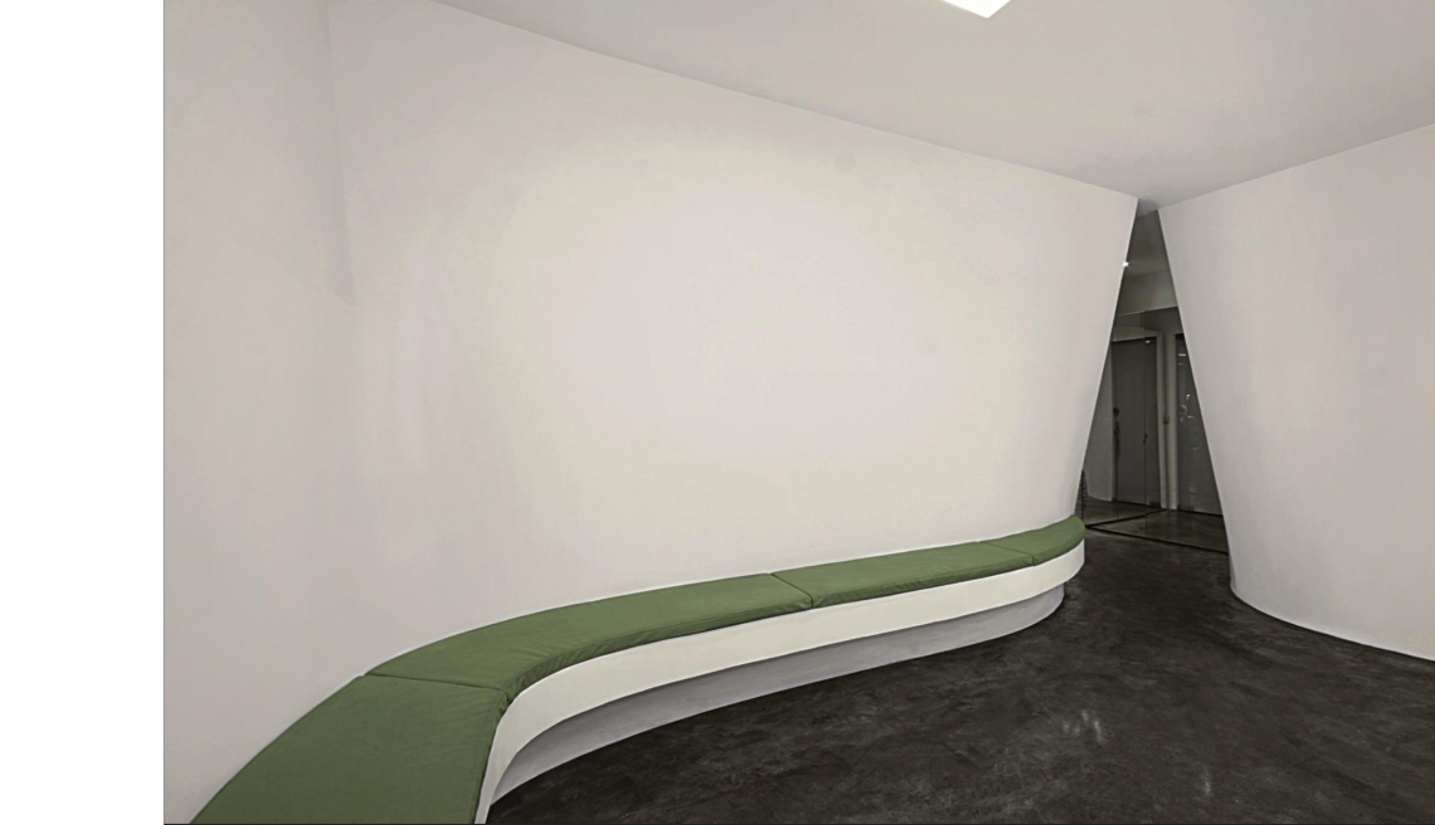 Beauty House — green curved bench in the waiting hall, the floor sweeping under it.
