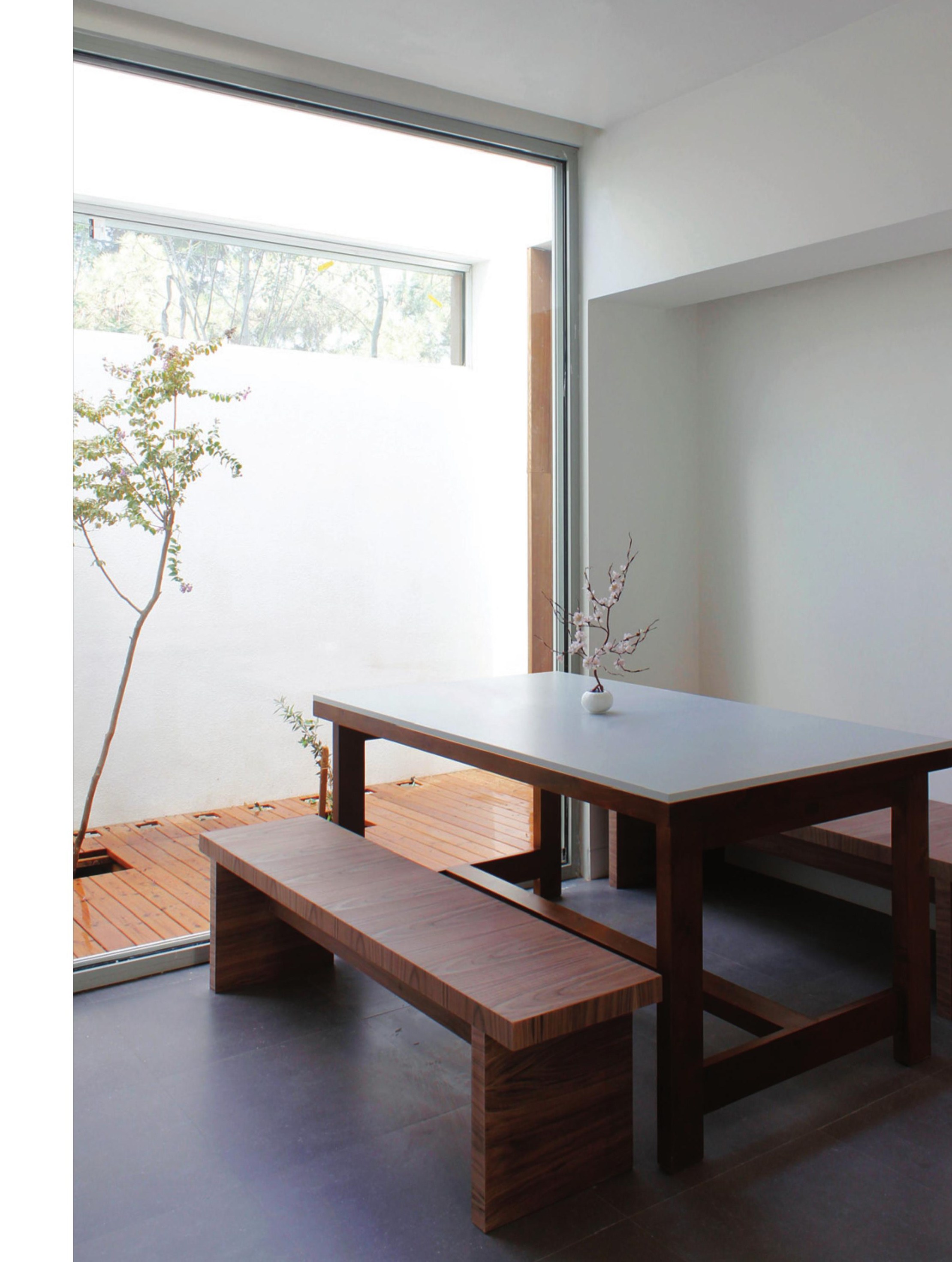 South courtyard with timber decking — the ground level living continues outdoors.